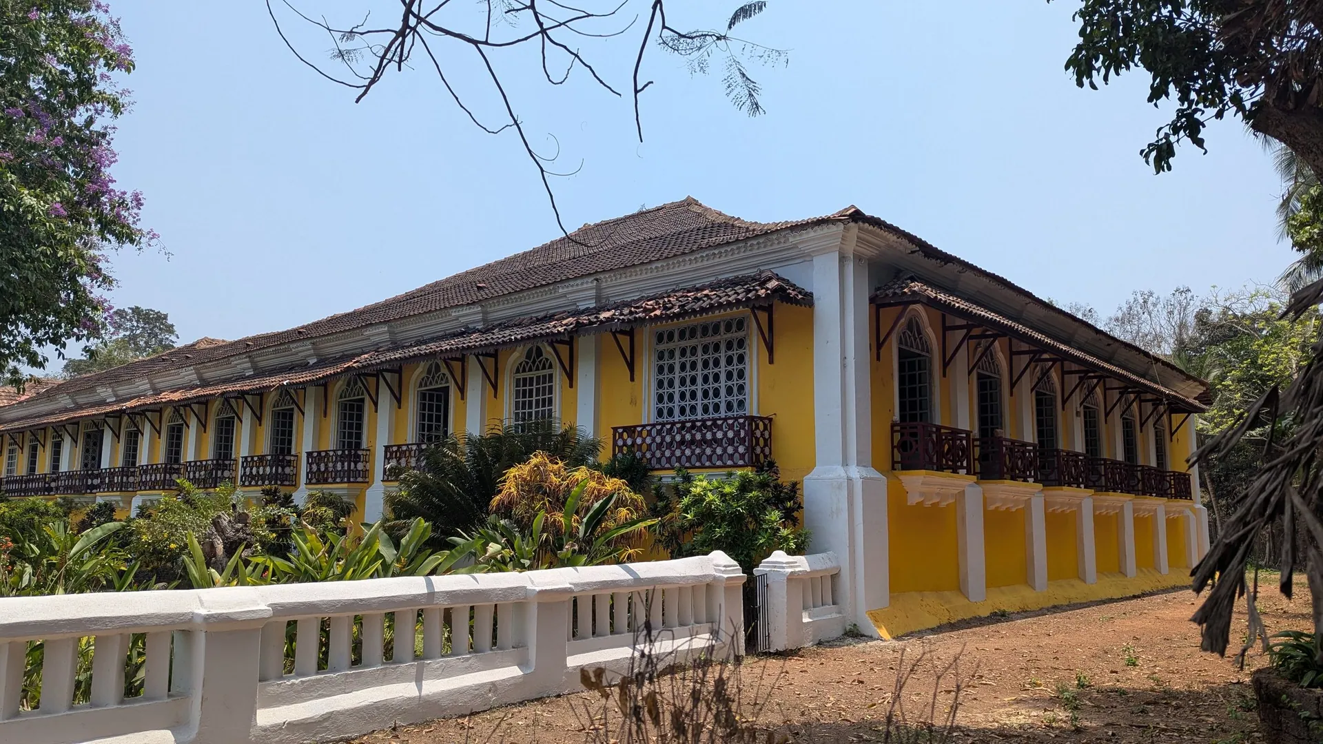 The long yellow facade of the Menezes Braganza house in Chandor, South Goa