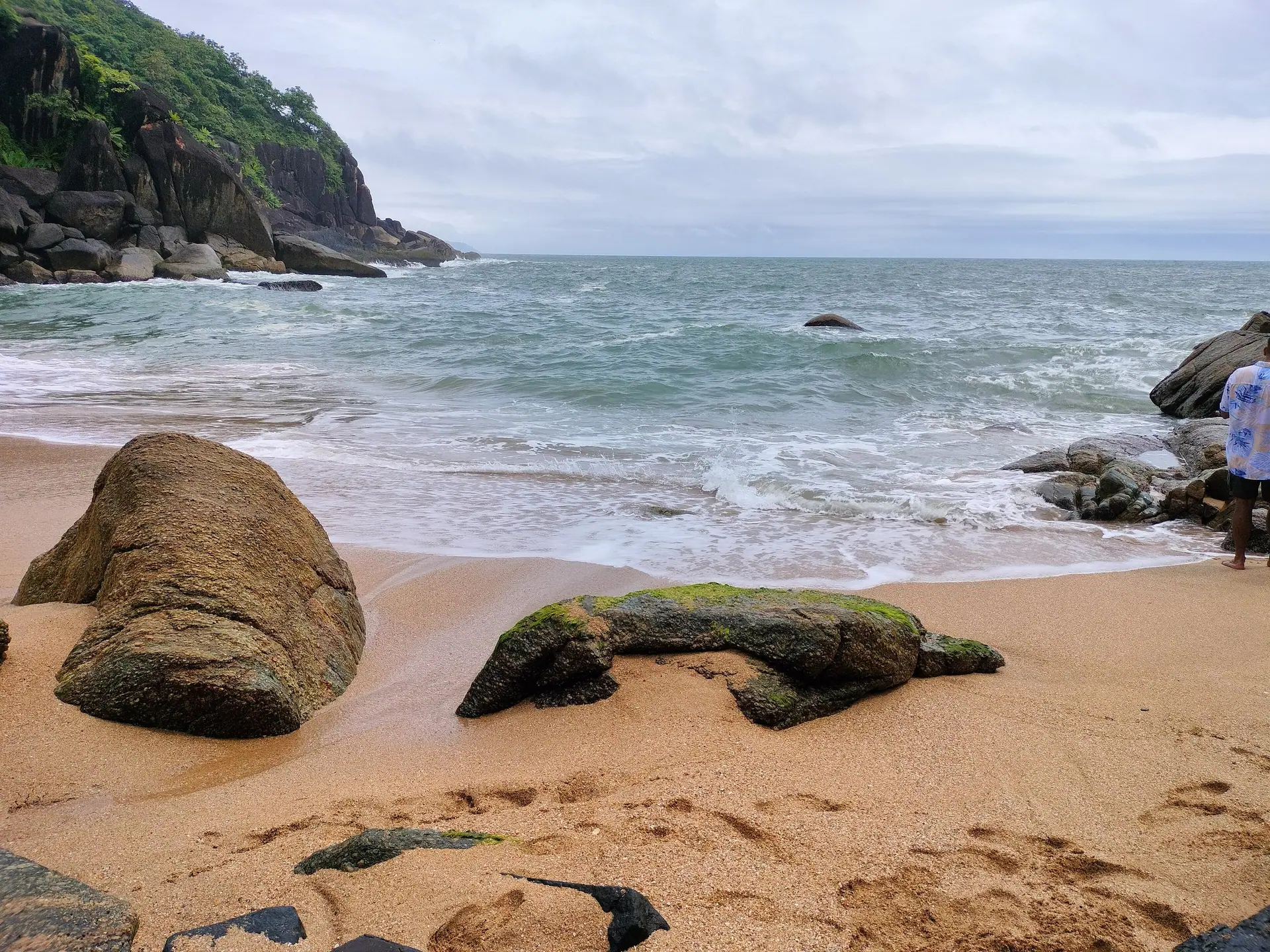 Rocks, sand and surf at Butterfly Beach, a small cove in South Goa