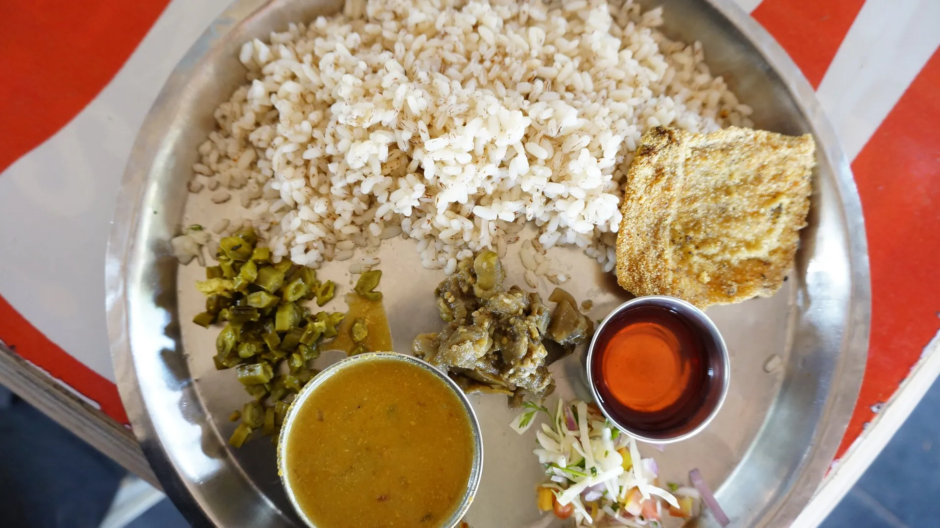 A typical Goan lunch of fish, curry and rice on a steel plate