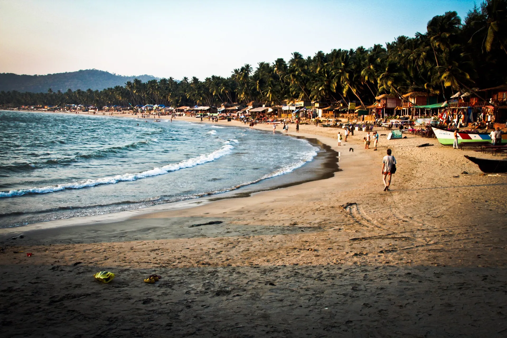 The curved bay of Palolem beach in South Goa, backed by palms