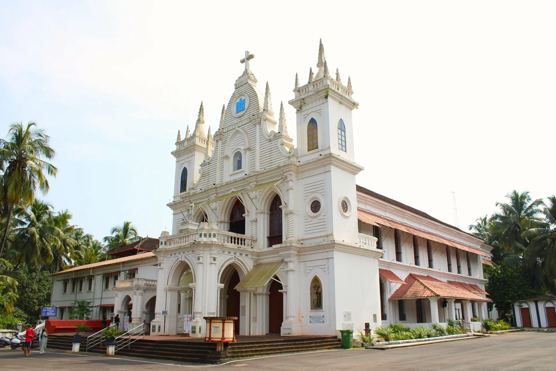 The white twin-towered facade of St Anthony's Church in Siolim, framed by coconut palms, North Goa