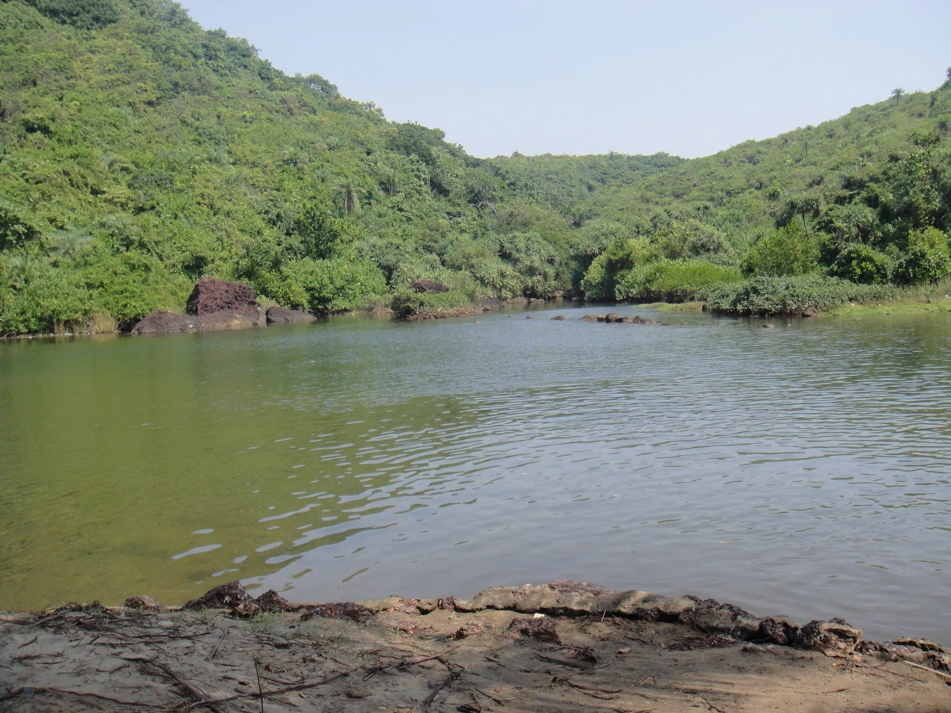 The still freshwater lake behind Arambol beach, ringed by jungle-covered hills, North Goa