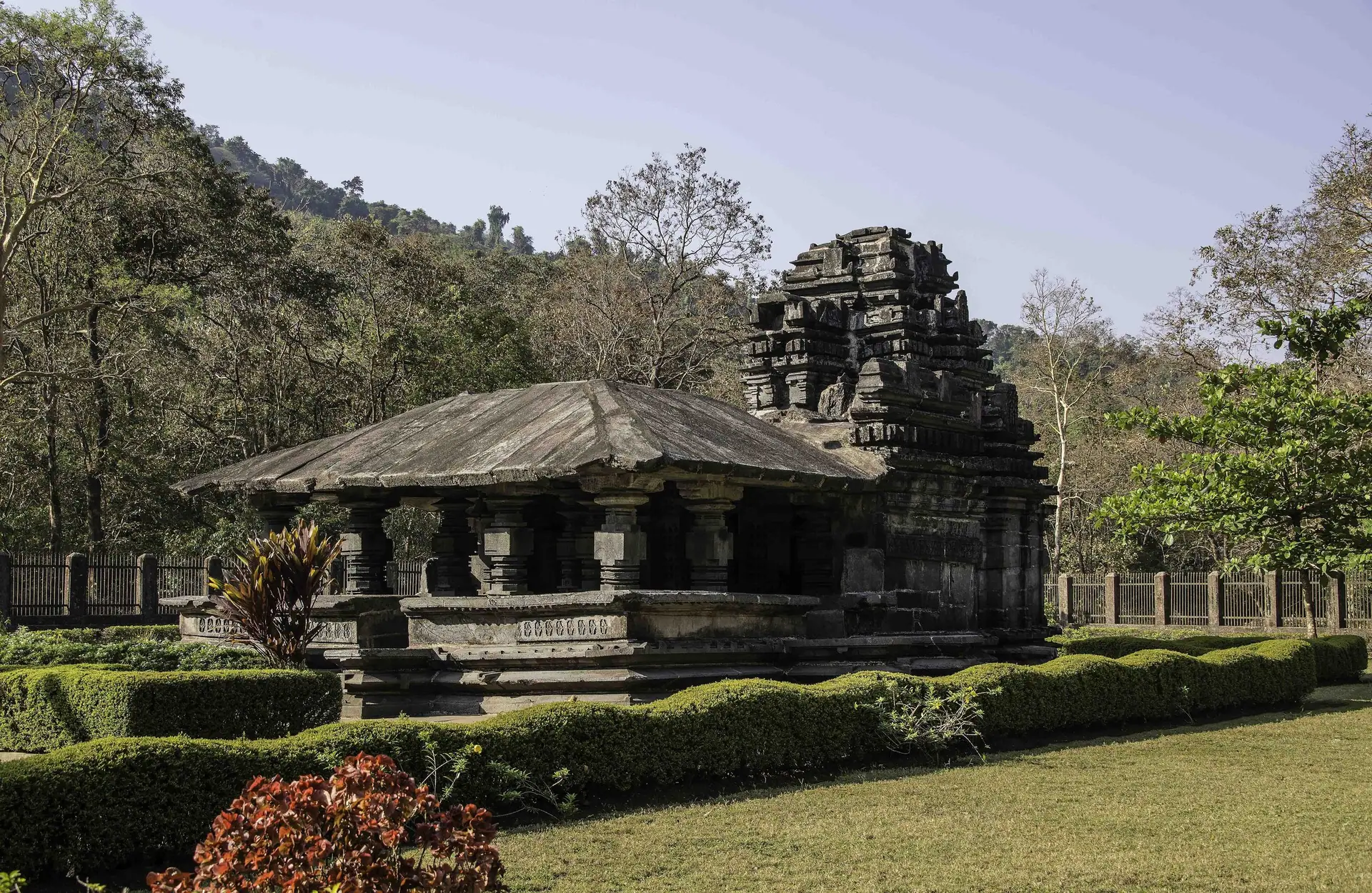 The small basalt Mahadev temple at Tambdi Surla, set in a garden in the forest